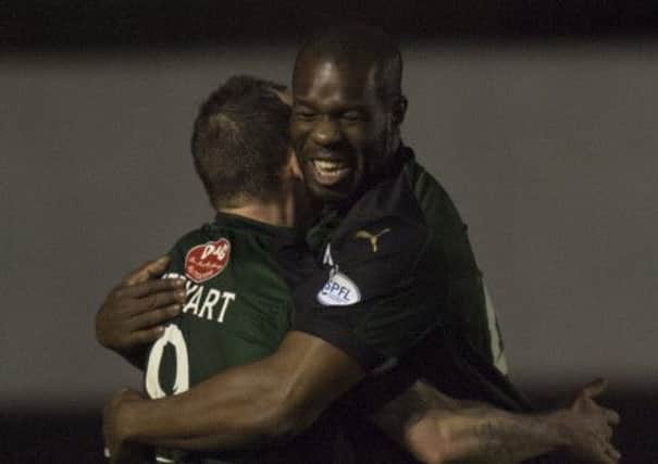 Christian Nade, right, is congratulated by Mark Stewart after his goal two minutes from time saw off Cowdenbeath. Picture: Toby Williams