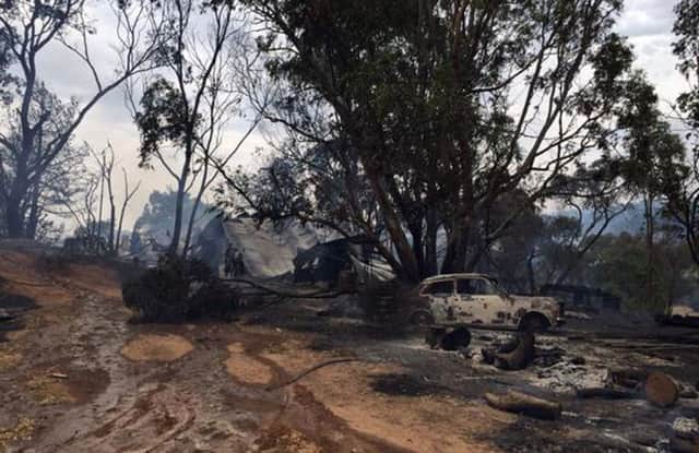 Tthe remains of a house and car after a bush fire destroyed them at Cudlee Creek in South Australia. Picture: Reuters