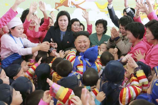 As North Korean leader Kim Jongun met children at an orphanage, tensions continued to rise between his country and the US. Picture: Reuters