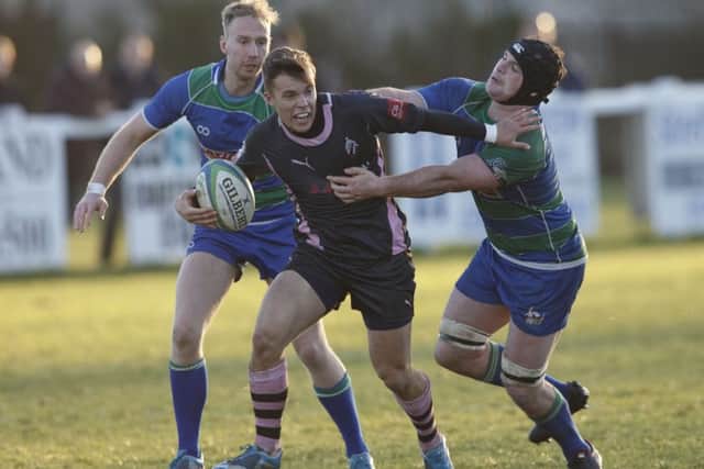 Hamiltons Fraser Dunnachie tries to halt the progress of Ayrs Gavin Lowe. Picture: Robert Perry