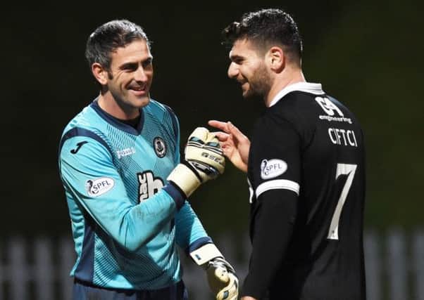 Thistle goalkeeper Paul Gallacher (left) jokes with Nadir Ciftci during the match. Picture: SNS