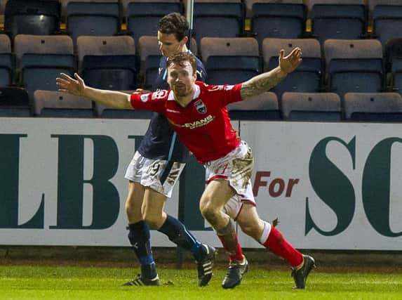 Craig Curran wheels away to celebrate after grabbing Ross County's equaliser. Picture: SNS