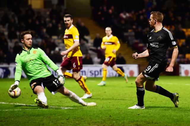 Adam Rooney fires Aberdeen into the lead as the Pittodrie men continue their dominant form at the top of the table. Picture: SNS Group