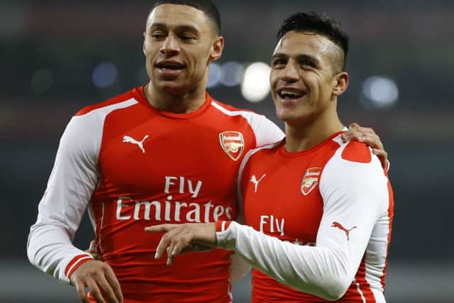 Alexis Sanchez, right, celebrates scoring the Gunners second goal with team-mate Alex Oxlade-Chamberlain. Picture: AP