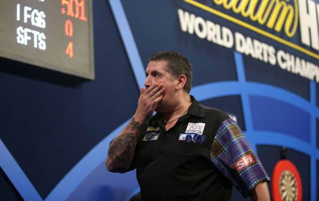 Gary Anderson savours the finest moment of his career at Alexandra Palace in London last night. Picture: PA
