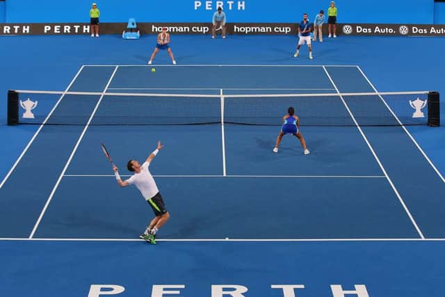 Andy Murray serves during his hard-fought doubles victory alongside Heather Watson. Picture: Getty