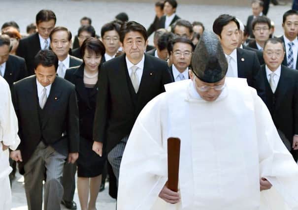 Shinzo Abe, centre, and his cabinet ministers, arrive at the Grand Shrine of Ise for a new year's prayer. Picture: AP
