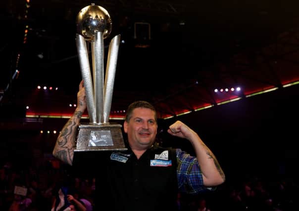Gary Anderson celebrates with the Sid Waddell trophy after defeating Phil Taylor in the final of the 2015 PDC World Darts. Picture: Getty