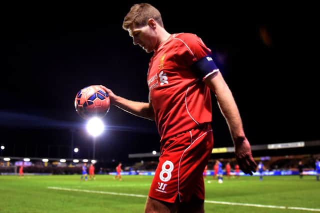 Two-goal hero Steven Gerrard bounces the ball before taking a corner at Kingsmeadow. Picture: Getty Images