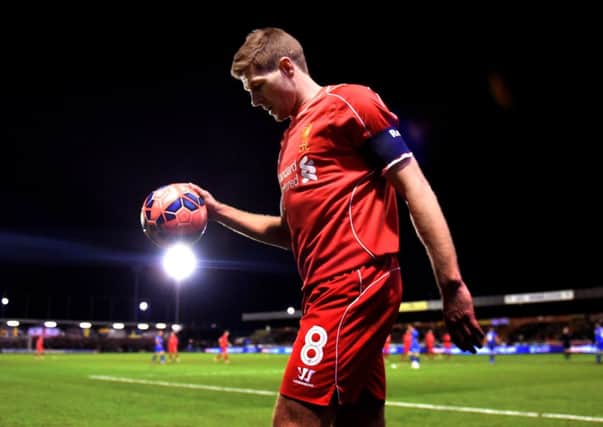 Two-goal hero Steven Gerrard bounces the ball before taking a corner at Kingsmeadow. Picture: Getty Images