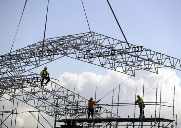Construction workers replace the roof of Glasgow School of Art's Mackintosh Building. Picture: John Devlin