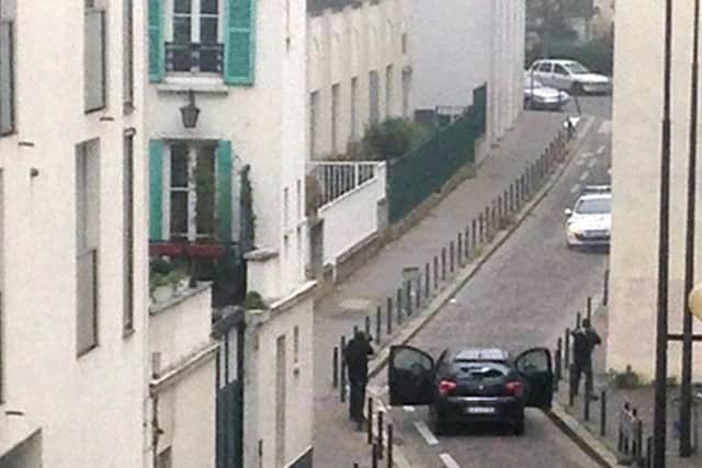 Armed gunmen face police near the Charlie Hebdo offices. Picture: Getty