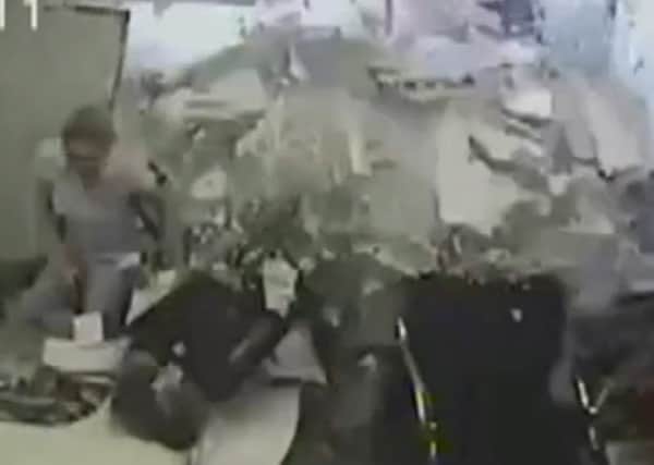 This office workers in Brazil had a narrow escape after a truck crashed into her desk. Picture: YouTube