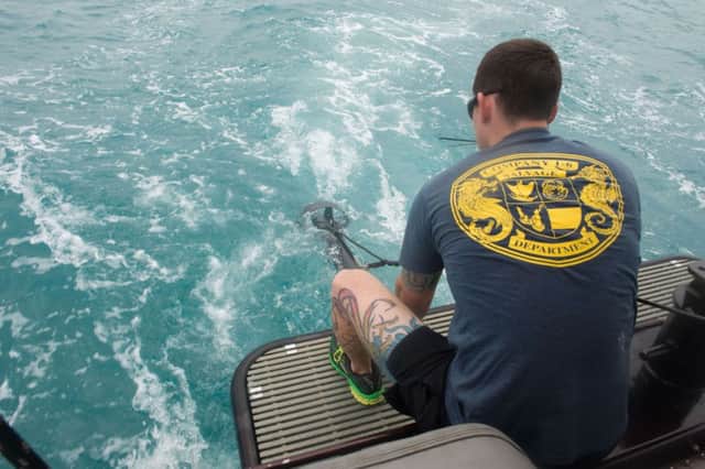 US navy diver Daniel Clarke scans the Java Sea for parts of the missing AirAsia jet and the bodies of its passengers. Picture: AFP/Getty