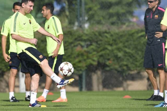 Barcelonas coach Luis Enrique watches Lionel Messi on the ball. Picture: Getty