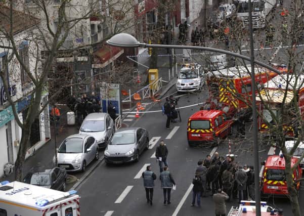 Police officers, firefighters and rescue workers gather at the site of a shooting in Montrouge, Paris. Picture: AP