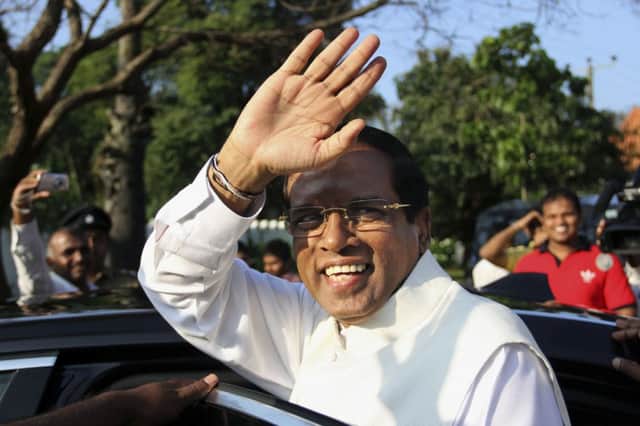 Maithripala Sirisena waves to supporters after casting his vote yesterday. Picture: AP
