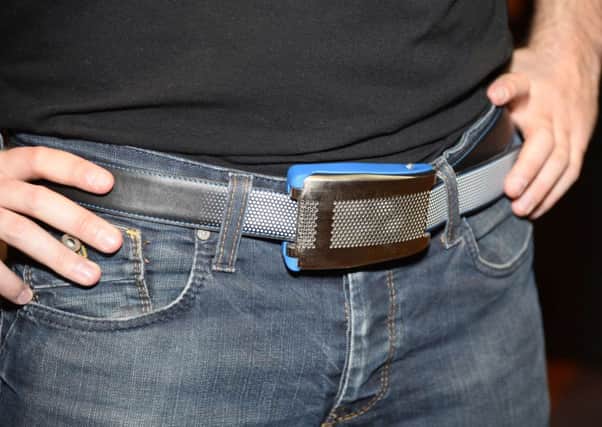 Emiota representative Johann Gobba wears Belty, a smart belt from Paris-based Emiota, at CES Unveiled. Picture: Getty