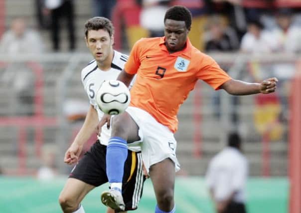 Genero Zeefuik vies with Germany's Kevin Pezzoni for the ball during a friendly match. Picture: Getty