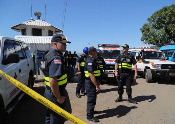 Costa Rican police and emergency workers await the arrival of tourists who were rescued after the catamaran sank. Picture: Getty
