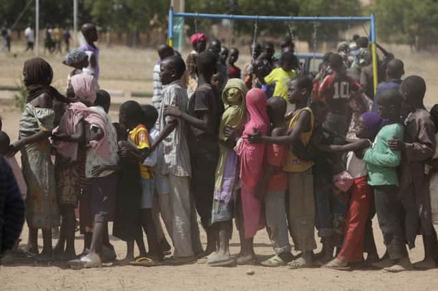 Nigerian children displaced after attacks by extreme Islamists Boko Haram line up in the refugee camp in Yola. Picture: AP