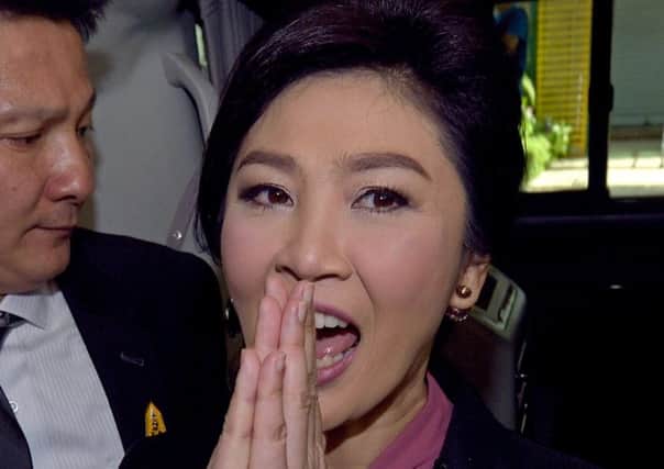 Ousted Thai prime minister Yingluck Shinawatra gestures a traditional greeting to members of the media after facing impeachment proceedings by the military-stacked National Legislative Assembly (NLA) at the parliament in Bangkok on January 9, 2015. Shinawatra launched a defiant defence on January 9 at the first hearing of impeachment proceedings that could see her banned from politics for five years and deepen the country's bitter divisions.  AFP PHOTO / PORNCHAI KITTIWONGSAKULPORNCHAI KITTIWONGSAKUL/AFP/Getty Images