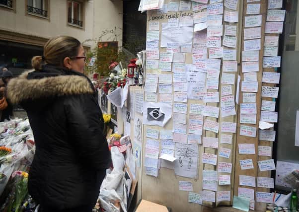 A woman views notes left near the offices at French satirical magazine Charlie Hebdo. Picture: Getty