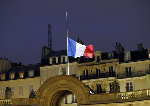 A French flag flies half-mast at the Elysee Palace in Paris, following  two days of terror in the French capital. Picture: AP