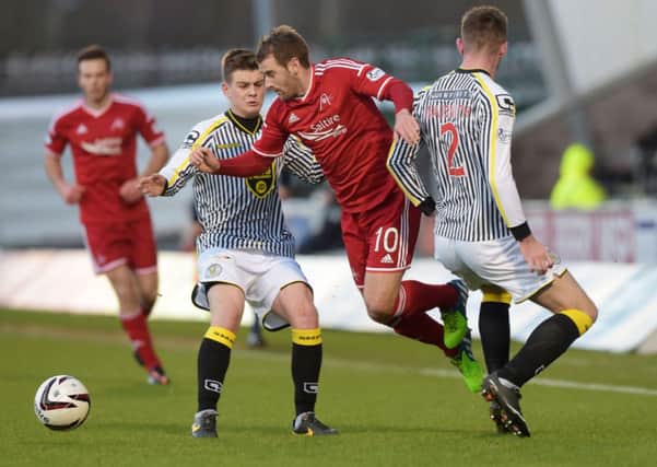 Aberdeen's Niall McGinn (centre) makes his way by Jason Naismith. Picture: SNS Group