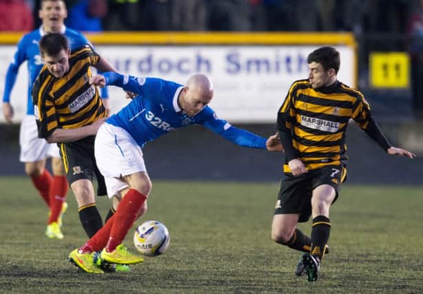 Goalscorer Nicky Law holds off the Alloa defence. Picture: SNS
