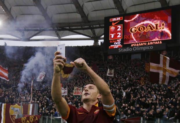 Francesco Totti celebrates his, and Roma's, second goal by taking a selfie with the fans. Picture: AP
