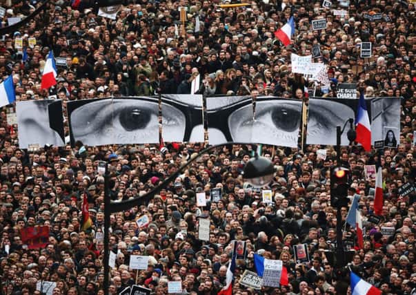 Demonstrators in Paris carry a representation of Charlie Hebdo editor Charb. Picture: Getty