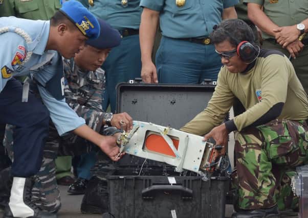 Military personnel pack the flight data recorder from AirAsia flight QZ8501 for safe transport to Jakarta for analysis. Picture: AP