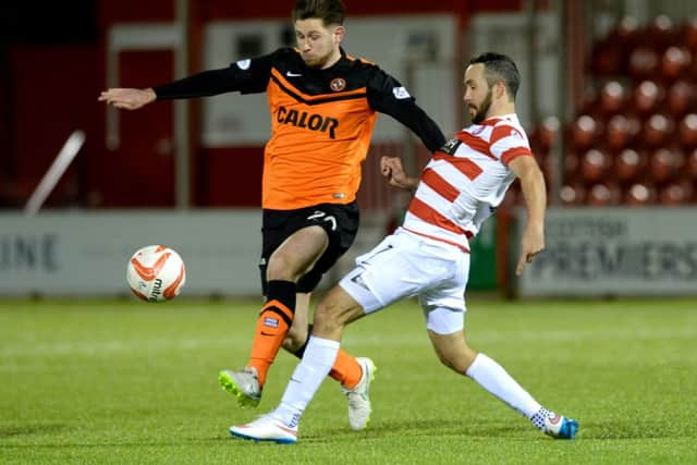 Hamilton's Dougie Imrie challenges Dundee United's Calum Butcher for the ball. Picture: SNS