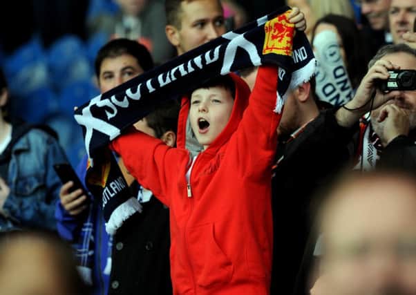 A young Scotland fan sings The Flower of Scotland, considered by many to be the nation's unofficial anthem. Picture: Lisa Ferguson