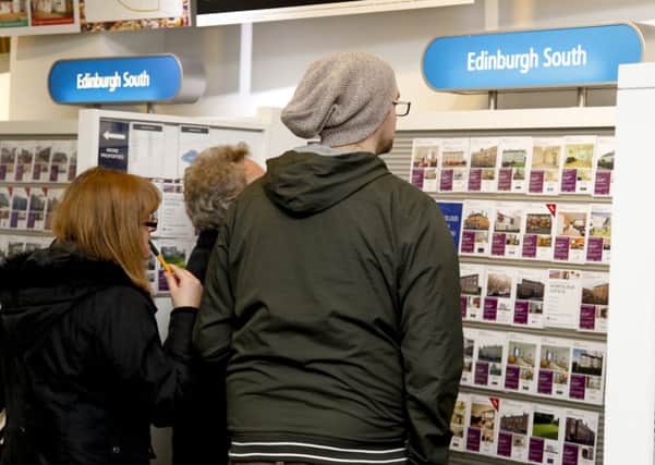 Prospective buyers check out house prices at the ESPC in George Street. Picture: Scott Louden