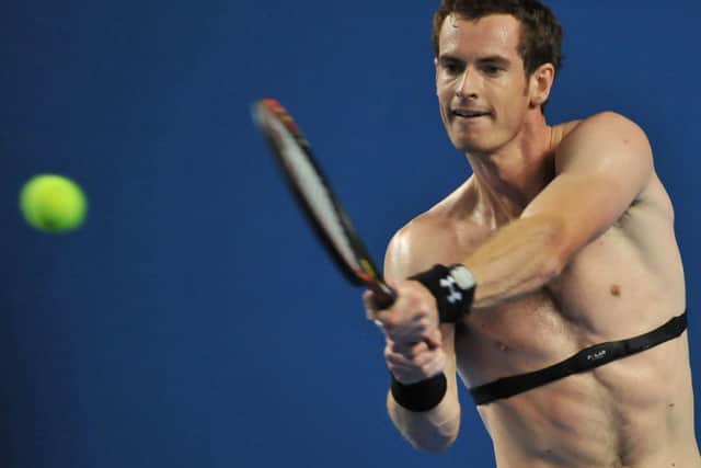 Andy Murray, wearing a device to monitor his heart-rate, hits a return during a training session yesterday. Picture: Getty Images