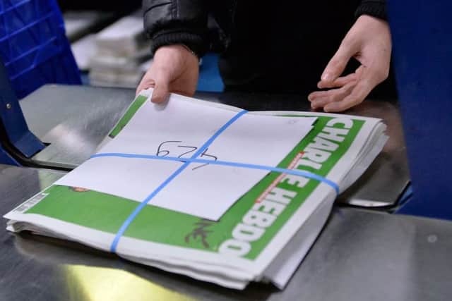 A worker prepares the new edition of Charlie Hebdo for delivery. Picture: Getty