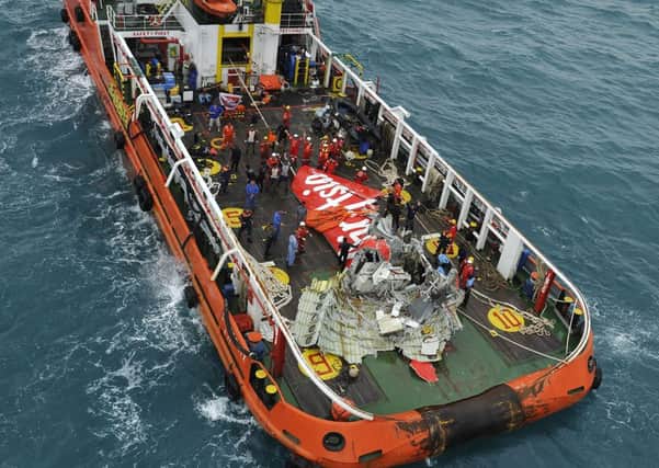 Part of AirAsia flight QZ8501 is lifted onto a Crest Onyx ship. Picture: Getty
