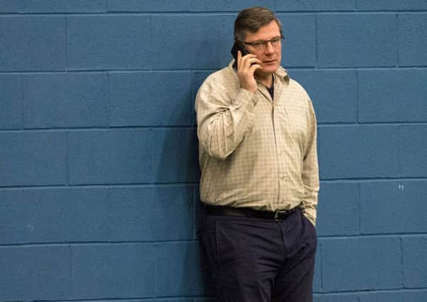 Craig Levein chats on his phone during training at the Riccarton complex yesterday. Picture: Alan Harvey/SNS