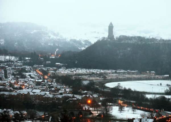 Snow-covered rooftops seen at Stirling Bridge and the Wallace Monument, Stirling. Picture: PA