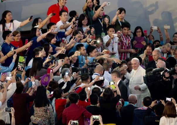 Crowds surround Pope Francis in Manila yesterday. Picture: AP