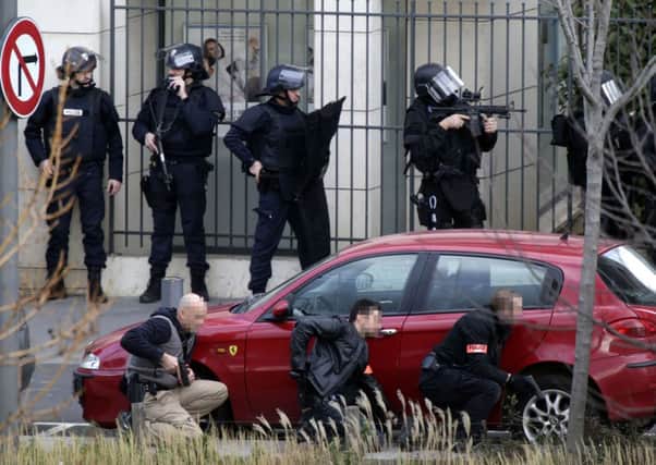 Armed police stand guard near the post office where an armed man is holed up with two hostages. Picture: Getty