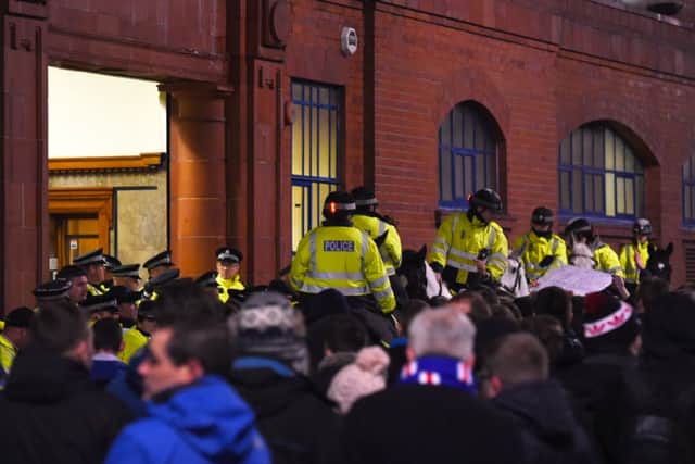 Police on horses move in as the Rangers fans protest outside of the stadium. Picture: SNS