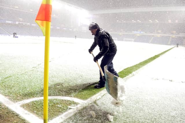 An Ibrox groundsman makes the pitch markings visible before kick-off. Picture: Lisa Ferguson