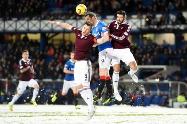 Jon Daly (centre) battles with Hearts pair Danny Wilson (left) and Alim Ozturk. Picture: SNS
