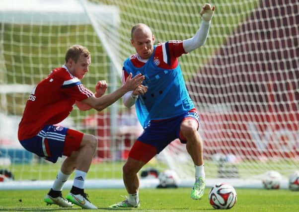 Arjen Robben, with bandaged hand, is challenged by Sebastian Rode during Bayern Munich's winter training camp in Qatar. Picture: Getty
