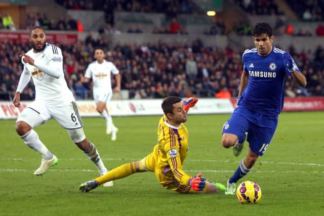 Its all too simple for Diego Costa as he rounds Lukasz Fabianski for goal number 3 after Federico Fernandezs error. Picture: Getty
