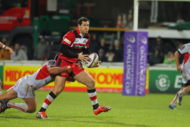 Tim Visser, who scored the first of Edinburghs two tries, is hauled back in Lyon last night. Picture:  Marc Galaor