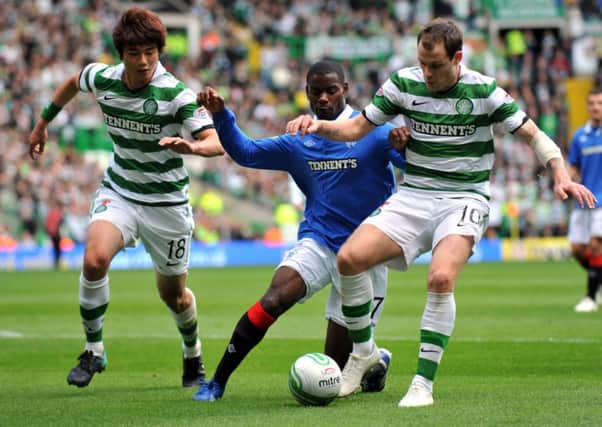 Mo Edu challenges Anthony Stokes as Ki looks on during a Celtic v Rangers match in October 2010. Picture: Jane Barlow